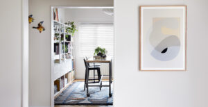 Maike Design bookshelves and workbench with artwork