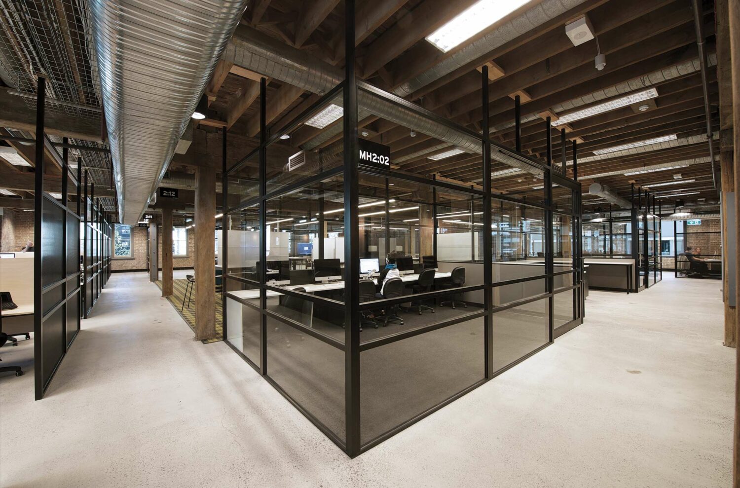 Maike Design Creative design school, warehouse conversion. Black framing and screens