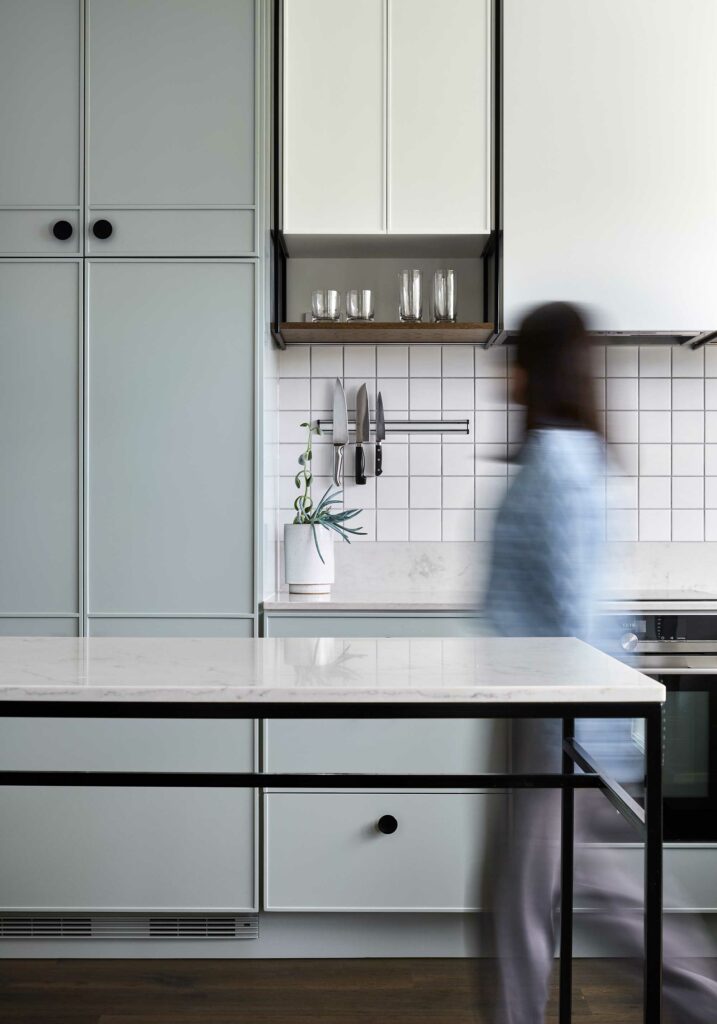 Maike Design light green kitchen. Custom cupboard design, black handles and marble benchtop.