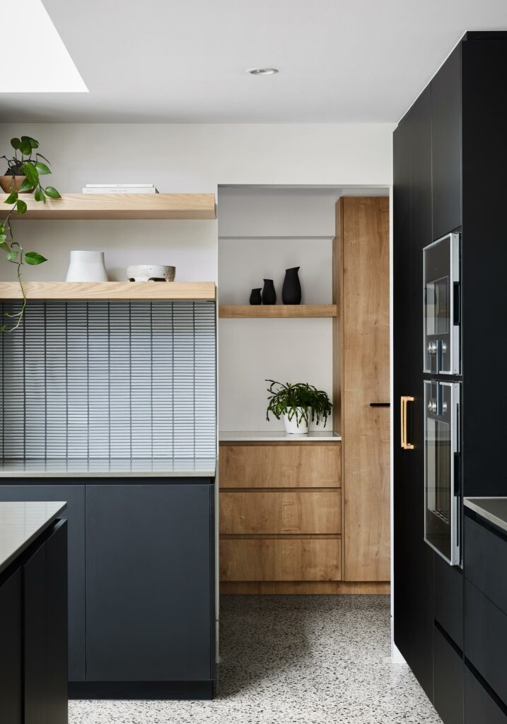 Maike Design Black kitchen and timber butler's pantry. Tiled splashback and timber shelves.